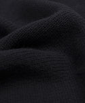 Close-up of the Cameron Crewneck in black, highlighting its knitted texture and soft, wavy folds—a lightweight sweater designed for comfort and a cozy feel.