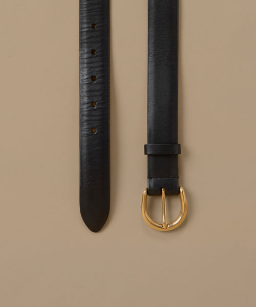 A black leather belt shown in two vertical views against a warm beige background, featuring a polished gold-tone buckle and a textured strap.