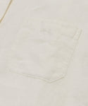 Close-up of the Linen Logan Shirt’s white pocket, showcasing stitching and texture details that define this boxy-fit button-up’s effortless style.