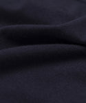 Close-up of the Merino Tank’s dark navy blue merino wool fabric, showing its soft texture, gentle folds, and smooth, slightly fuzzy surface.