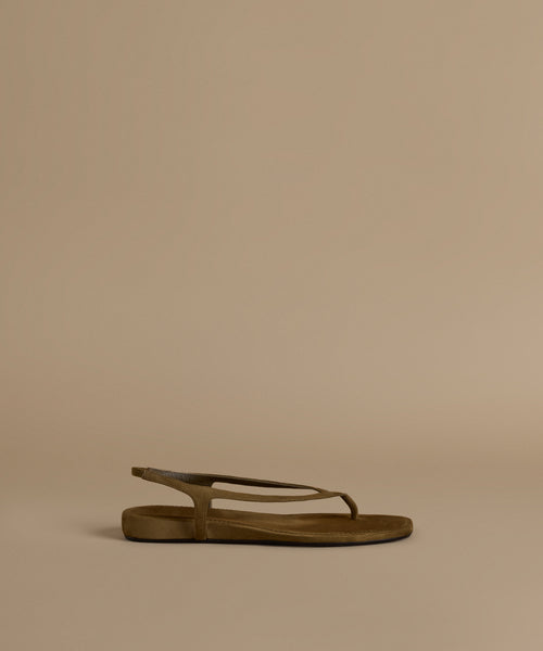 Olive sandal on a beige background