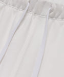 Close-up of the waistband on the Bay Sweatpant, showcasing its elastic band and two white drawstrings over soft brushed fleece fabric.