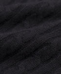 Close-up of the Cable Nell Turtleneck in black, highlighting its cozy cable knit texture and soft, slightly raised design that embodies classic turtleneck style.