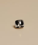 The Campbell Cigar Band, a wide polished ring with a smooth curved surface, is displayed on a plain beige background.