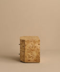 The Carbon Nightstand is a small, square modern piece made of light wood with visible grain and two drawers featuring round metal handles, shown against a plain beige background.