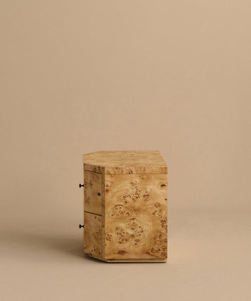 The Carbon Nightstand is a small, square modern piece made of light wood with visible grain and two drawers featuring round metal handles, shown against a plain beige background.