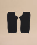 A pair of Fingerless Cashmere Gloves in black with thumb holes, displayed flat side by side on a beige background.