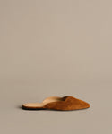 The Clara Mule is an Italian-made shoe in cognac brown suede with a pointed toe and open back, shown on a neutral background.