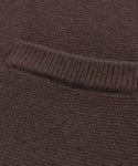 Close-up of the Cooper Cardigan, showcasing its brown knit, structured silhouette, and ribbed detailing along a horizontal seam—highlighting texture and weave for versatile styling.