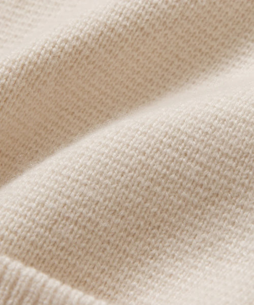 Close-up of the Cooper Cardigans soft Warm Ivory fabric with a textured knit and gentle folds—ideal for bringing comfort and style to its structured silhouette.