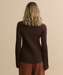 A person with shoulder-length wavy blonde hair is seen from behind, wearing the Dara Top in brown with matching brown pants against a plain beige background.