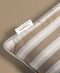 Striped fabric with a Jenni Kayne label on a beige background