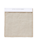 A beige Fabric Swatch Drift Linen made from Belgian flax linen, featuring visible edge stitching and attached to a white card labeled jenni kayne home at the top.