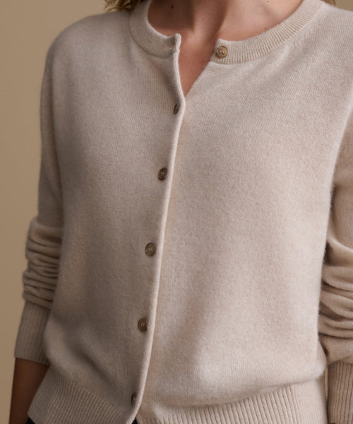 Model wearing an oat cashmere cardigan.
