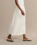 Someone is dressed in a white skirt and the Gia Sandal.