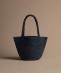 navy hollis bag on a beige background