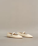 The Lana Flat is a pair of white shoes with a tapered toe, adding a touch of feminine flair.