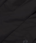 Close-up of the Lara Top in smooth, slightly matte Italian washed poplin, featuring visible stitching and a small button detail at the bottom right.
