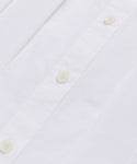 Close-up of the Lara Top, showcasing its Italian washed poplin fabric with white buttons and precisely sewn buttonholes along the front placket.