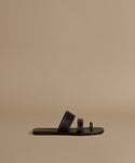 Brown sandal on a beige background