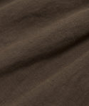 Close-up of brown fabric with a slightly rough texture and visible weave, highlighting natural folds—ideal for warm-weather outfits like the Linen Logan Short.