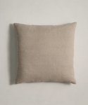 A square, light beige Linen Pillow with a natural linen texture is set against a plain light-colored background.