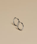 Medium Eloise Hoops are displayed on a smooth, beige surface, with gentle shadows cast beneath them.
