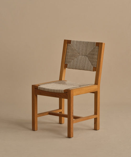 The Outdoor Montecito Dining Chair Frame, with its light brown wooden structure and ECOLENE seat and backrest, features simple, clean lines and a minimalist design reminiscent of classic outdoor teak dining chairs.