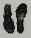 The Eve Sandal is a pair of black minimalist sandals crafted from soft Nappa leather.