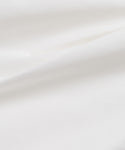 Close-up of smooth white Italian cotton poplin with gentle folds and soft shadows, capturing the minimal and clean aesthetic of the Newport Short—ideal for summer shorts collections.