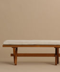 The Outdoor Garden Dining Bench features solid teak construction and a Tempotest fabric cushion, showcased against a simple beige background.