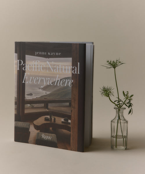 Book titled 'Pacific Natural Everywhere' by Jenni Kayne with a vase of flowers on a neutral background
