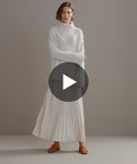 Thumbnail for video: Model walking in-studio wearing Cashmere Jet Turtleneck.