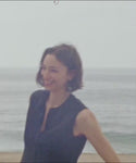 Thumbnail for video: Woman wearing a navy blue top outside by the ocean.