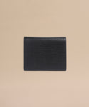 The Reece Leather Wallet is a mid-size black accessory crafted from textured leather with a subtle lizard skin pattern, shown on a plain beige background.