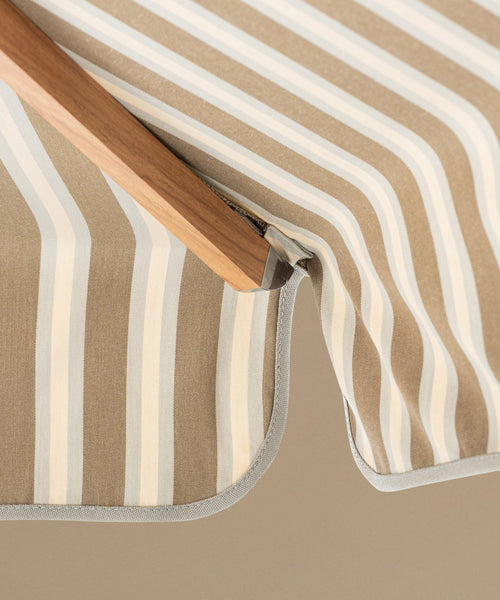 Striped patio umbrella on a beige background