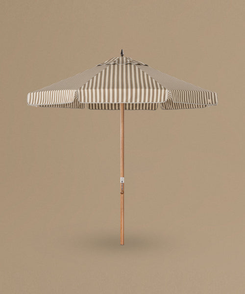 Striped patio umbrella on a beige background