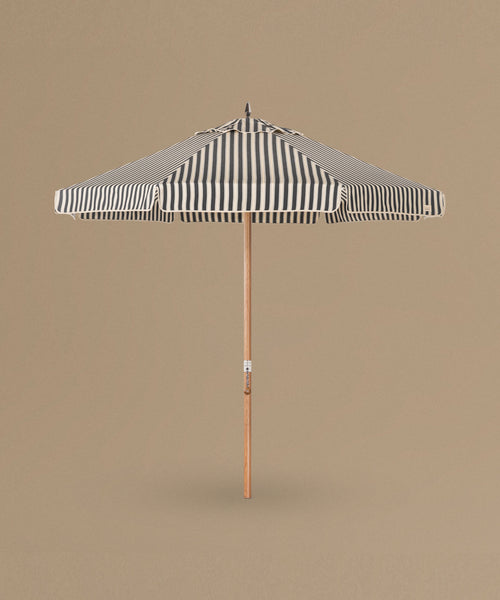 Striped patio umbrella on a beige background