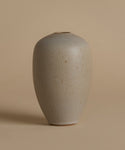 Beige ceramic vase on a beige background