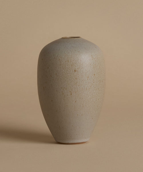 Beige ceramic vase on a beige background
