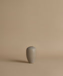 Gray ceramic vase on a beige background
