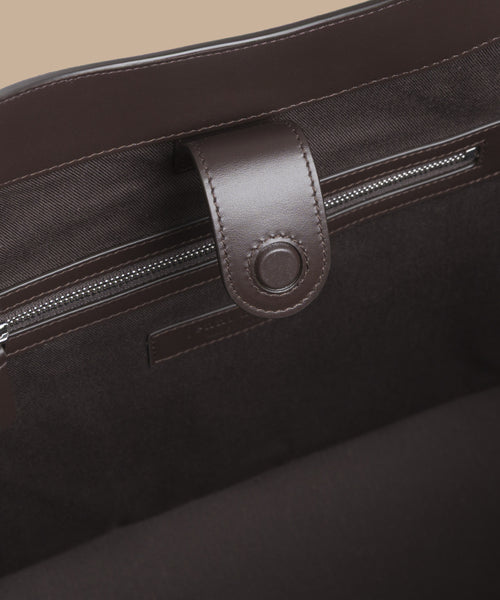 Close-up of the Suede Agnes Tote interior, highlighting a zippered pocket and leather snap tab closure—great as a chic laptop bag or suede tote.