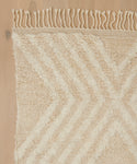 A close-up of the Cabin Rug reveals its intricate patterns and textures, showcasing the artistry behind each hand-knotted Moroccan-inspired wool piece.