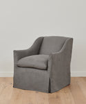 The Miramar Chair, handmade in the USA, features a loose slipcover and boxy shape with curved arms—perfect for adding timeless comfort and style to any space.
