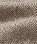 Close-up of the Miramar Sofa Slipcover’s coarse, woven burlap fabric in natural beige, highlighting its textured surface and rough fibers—reminiscent of Belgian linen—with raised ridges and gentle fold shadows.