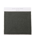 The Fabric Swatch Slate Linen by jenni kayne home features a textured, dark gray-green woven material on a white card, ideal for adding refined style to your Pacific Bed.