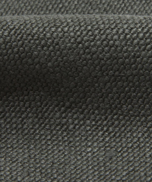 A close look at the Fabric Swatch Slate Linen showcases a dark gray, pebbled texture with bumpy folds, indicating softness and durability—ideal for upholstering the Pacific Bed.