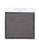 The Fabric Swatch Smoke Linen features a square, textured gray fabric with dark braided edges and a white label at the top—ideal for pairing with the Miramar Sofa.
