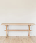 The Oak Entry Table stands against a white wall on a light wood floor, showcasing clean lines and minimalist design inspired by Jenni Kayne furniture. Its uncluttered surface enhances the simple, modern look.