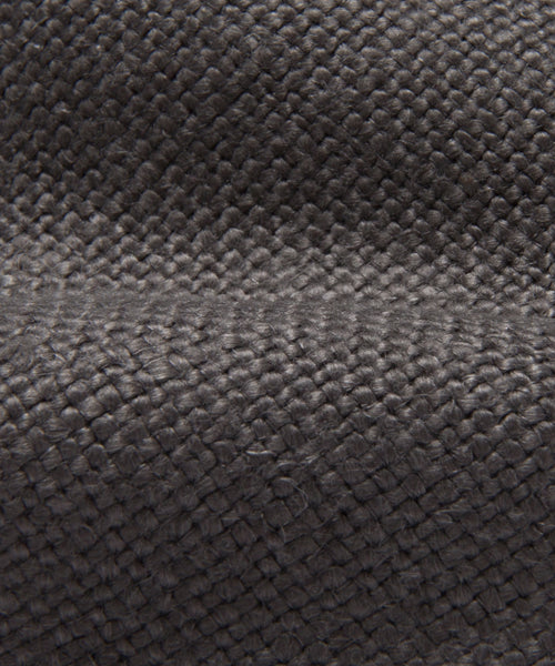 Close-up of the Miramar Sofa Slipcover in dark gray textured fabric featuring a visible woven pattern and a subtle horizontal ridge—ideal for adding a touch of sophistication to your sofa.